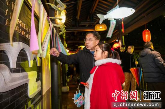 小朋友在秀溪水街的長廊里猜燈謎 沈勇強(qiáng) 攝